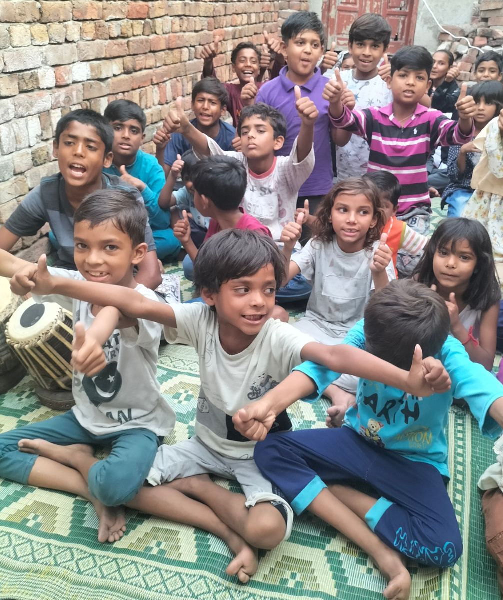 A group of joyful children giving a thumbs-up