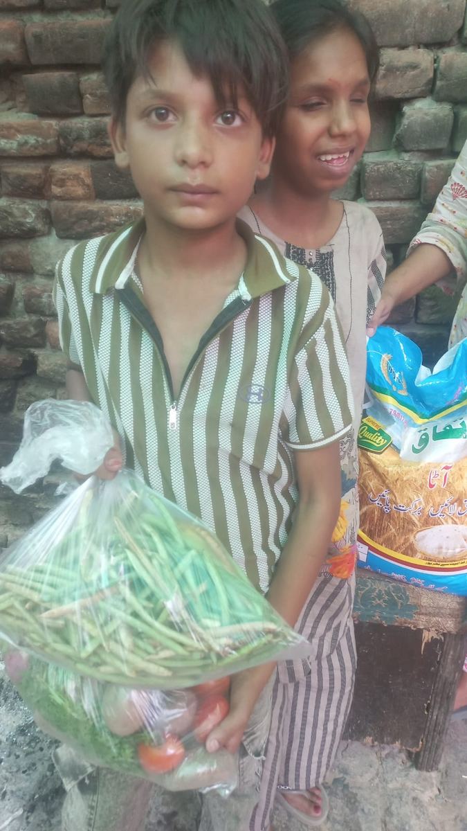 A child holding groceries for his family