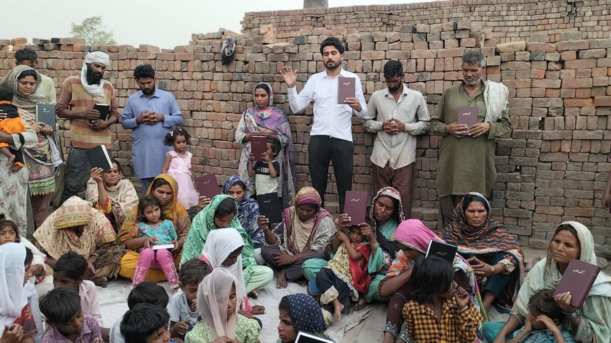 Very poor families gathered in a courtyard