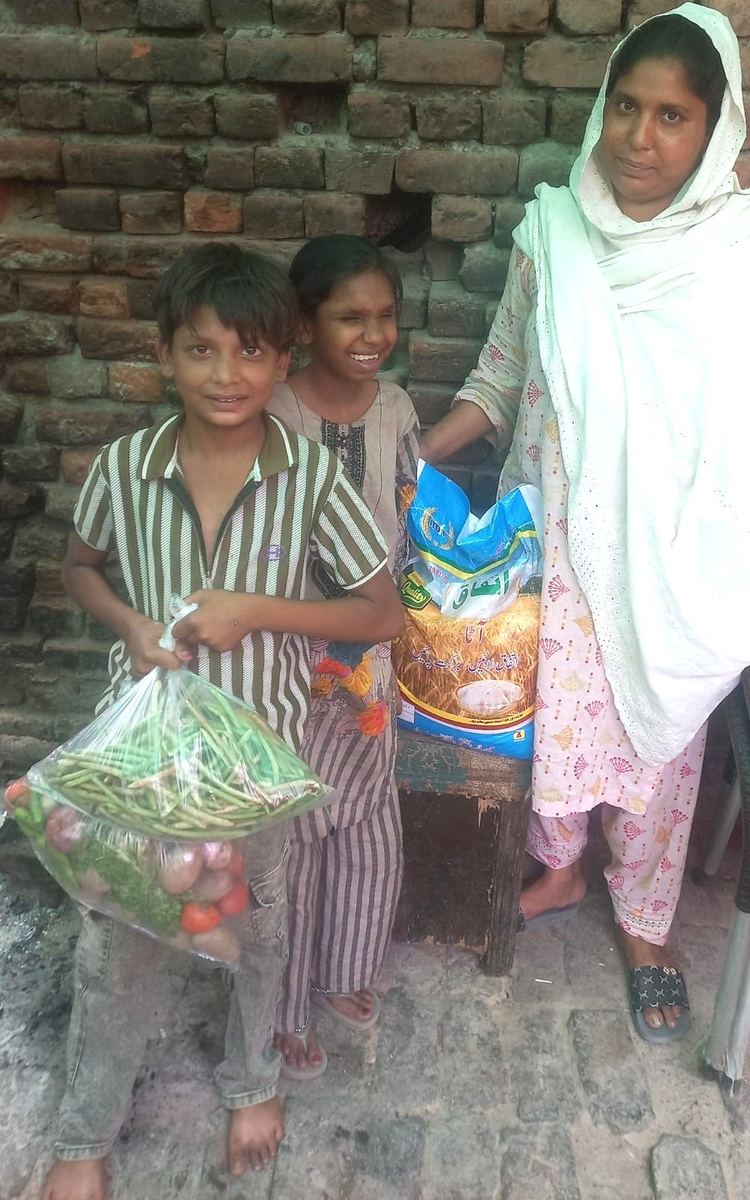 A widow and her daughter receiving groceries