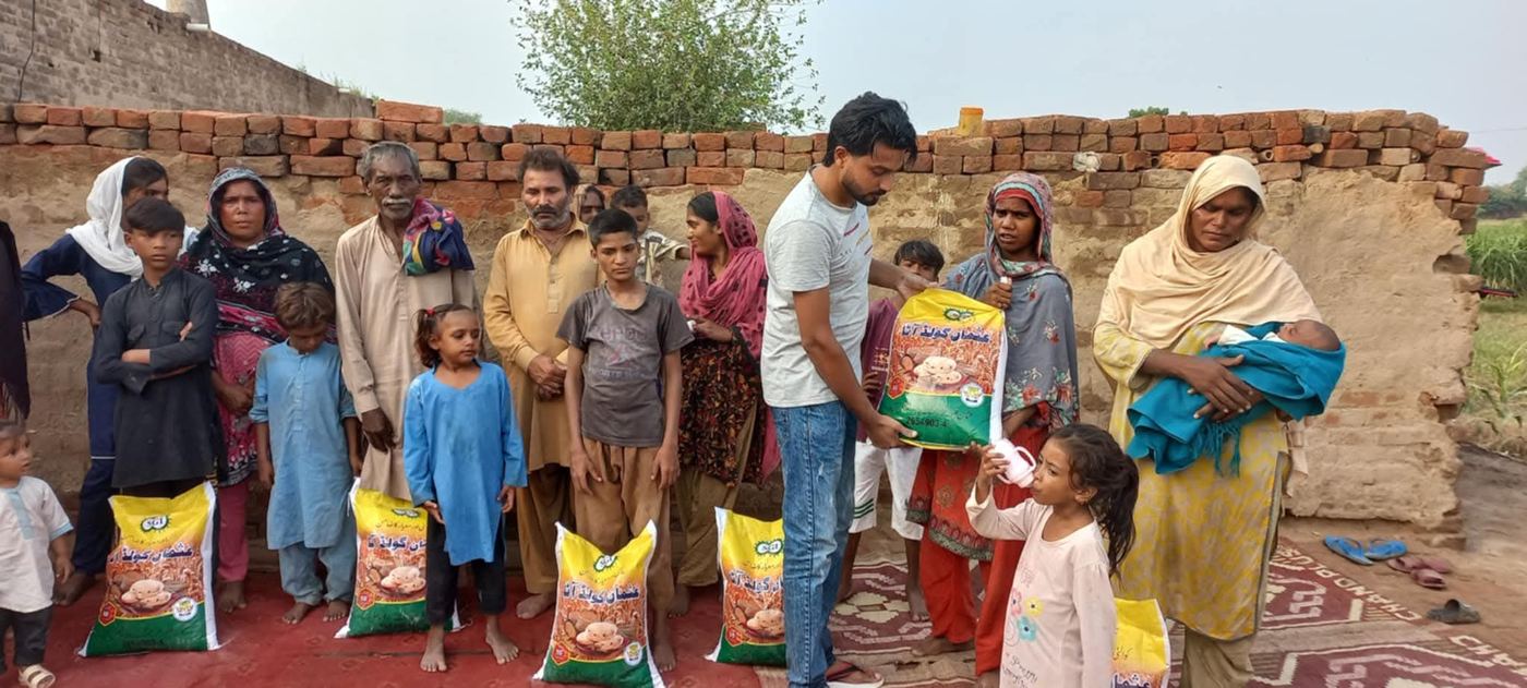 Christian families receiving bags of flour