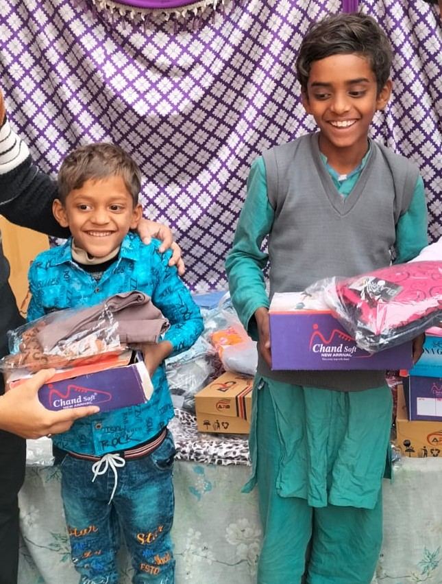 Two children holding boxes of new shoes